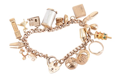 Lot 129 - A charm bracelet in 9ct gold, composed of a...