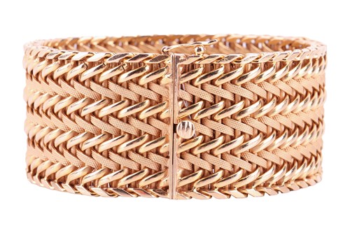 Lot 35 - A wide woven link bracelet, flat with textured...