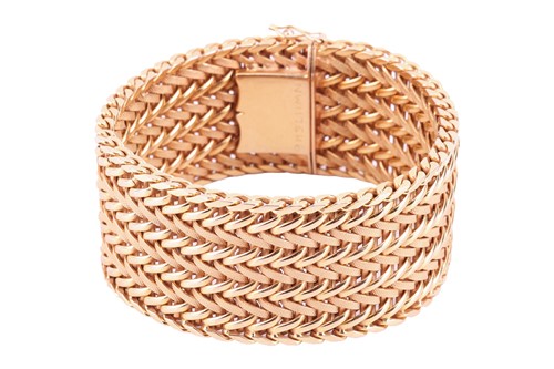 Lot 35 - A wide woven link bracelet, flat with textured...