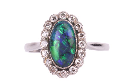 Lot 93 - An opal doublet and diamond cluster dress ring,...
