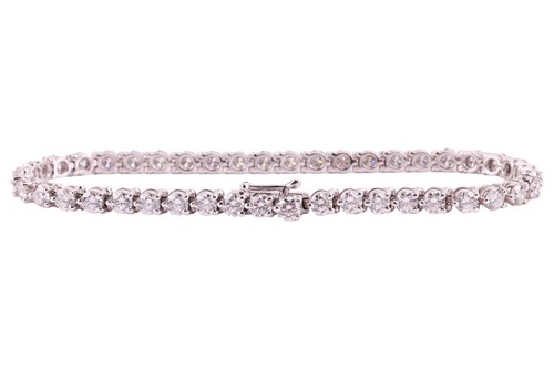 Lot 50 - A diamond line bracelet by David Morris, claw...