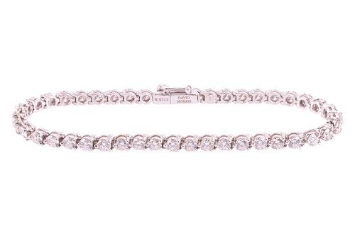 Lot 50 - A diamond line bracelet by David Morris, claw...