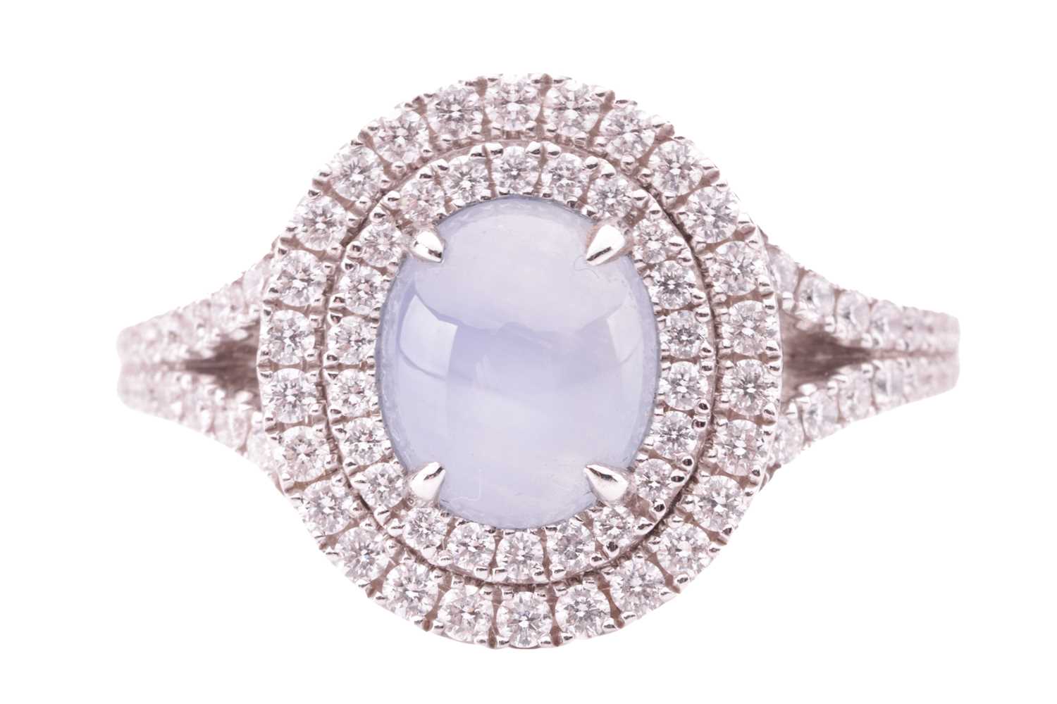 Lot 100 - A star sapphire and diamond cluster ring in...