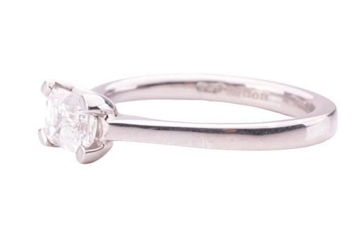 Lot 115 - A diamond solitaire ring, featuring an emerald-...