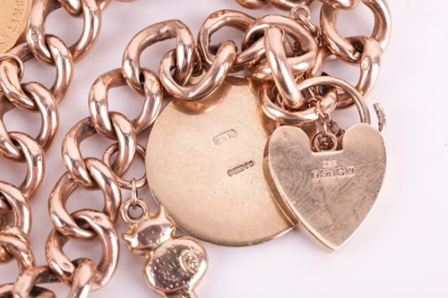 Lot 44 - A 9ct gold charm bracelet featuring nine...