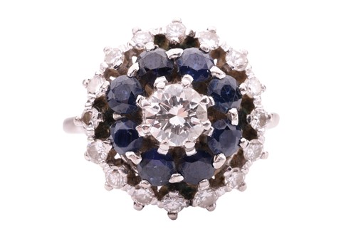Lot 127 - A sapphire and diamond cluster ring, featuring...