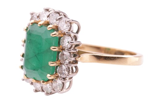 Lot 122 - An emerald and diamond cluster ring, set with...