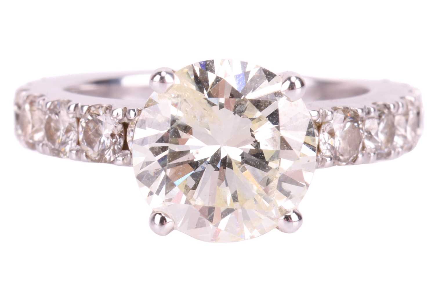 Lot 135 - A diamond solitaire ring with diamond set...