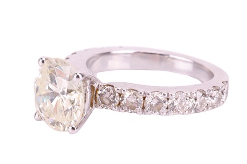Lot 135 - A diamond solitaire ring with diamond set...
