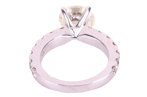 Lot 135 - A diamond solitaire ring with diamond set...