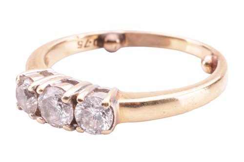 Lot 23 - A diamond three-stone ring, claw-set with...