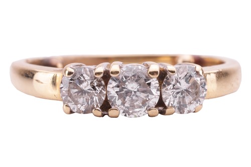 Lot 23 - A diamond three-stone ring, claw-set with...