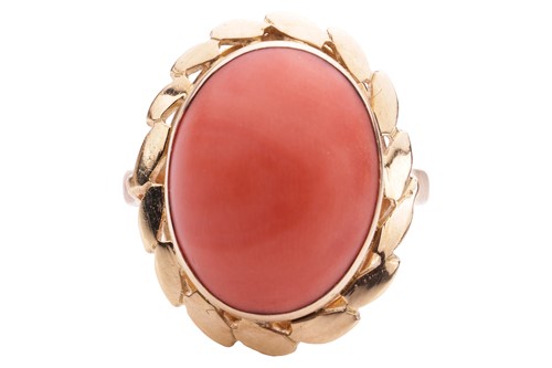 Lot A single-stone coral dress ring, the oval...
