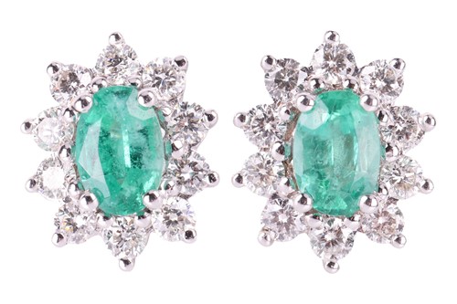 Lot 144 - A pair of emerald and diamond halo stud...