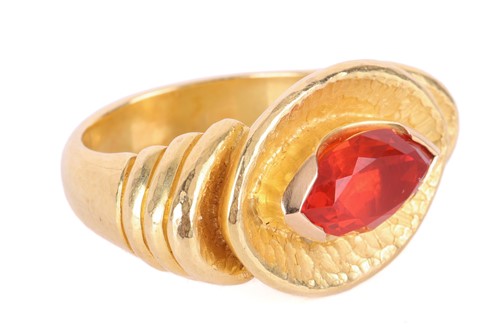 Lot 48 - A Modernist cocktail ring set with fire opal,...
