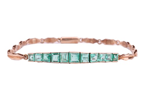 Lot 152 - An Art Deco emerald line bracelet, set with a...