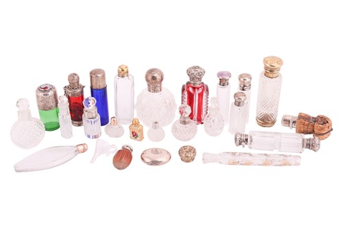 Lot 40 - A collection of cut glass scent bottles, many...