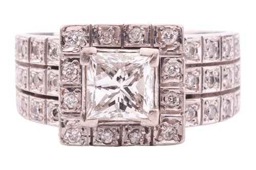 Lot 27 - A princess-cut diamond cluster ring, featuring...