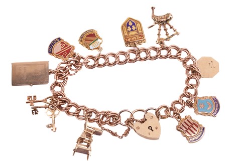 Lot 57 - A 9ct gold charm bracelet featuring ten charms...