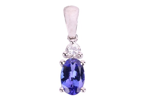 Lot 49 - A tanzanite and diamond pendant, claw-set with...