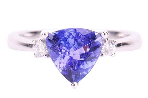 Lot 128 - A trilliant-cut tanzanite and diamond ring in...