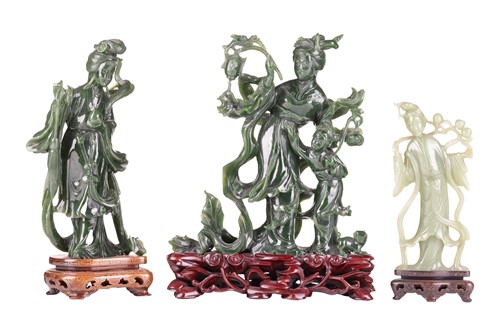 Lot 177 - A Chinese spinach green carved jade figure of...