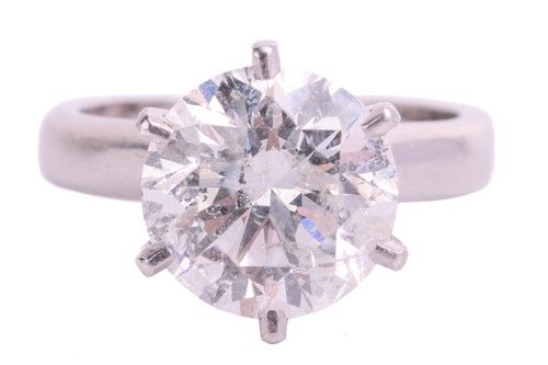 Lot 54 - A diamond solitaire ring in platinum, claw-set...