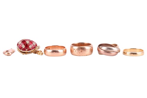 Lot 109 - Four wedding rings and two charms; to include...