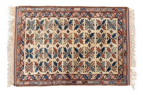 Lot 47 - A small ivory ground Kazak rug with a field of...