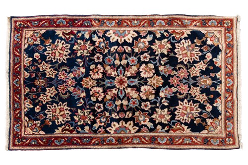 Lot 48 - A small dark blue ground Kerman rug,...