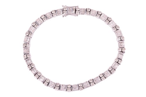 Lot 127 - A diamond tennis bracelet, each link...