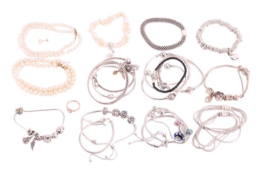 Lot 37 - Twenty one Pandora bracelets, some with charms,...