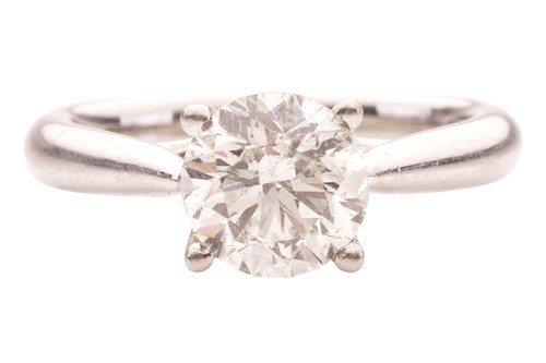Lot 98 - A diamond solitaire ring in platinum,...