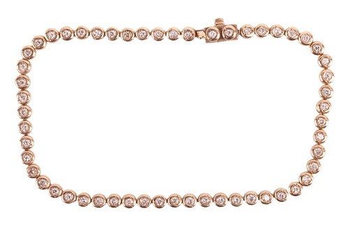 Lot 156 - A diamond tennis bracelet, set with a...