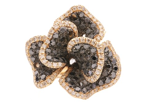 Lot 146 - A white and black diamond set stylised floral...