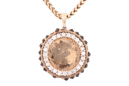 Lot 144 - A diamond-set medallion pendant on chain, the...