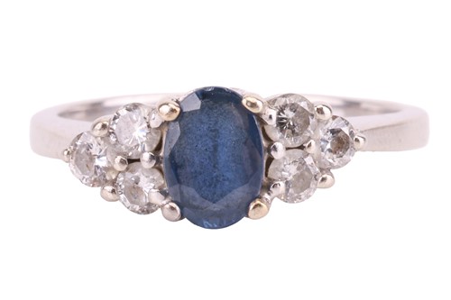 Lot 18 - A sapphire and diamond ring, set with an oval...