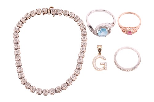 Lot 102 - A diamond-set line bracelet, three gem-set...