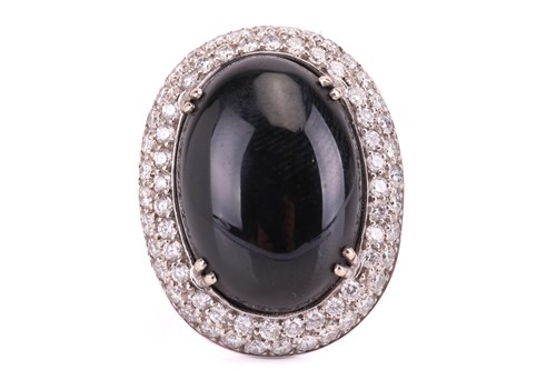 Lot 30 - A large Whitby jet and diamond halo dress ring...