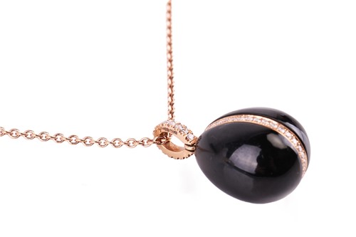 Lot 33 - A Fabergé Whitby jet and diamond egg pendant,...