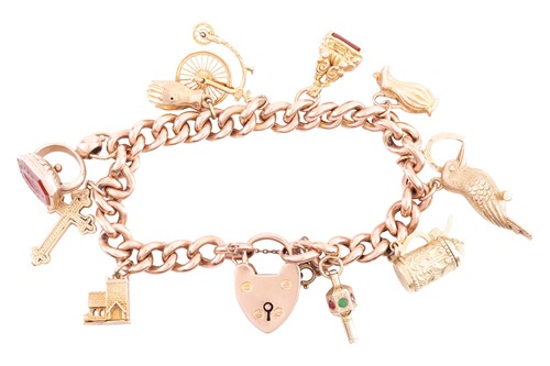 Lot 113 - A charm bracelet in 9ct rose gold, composed of...