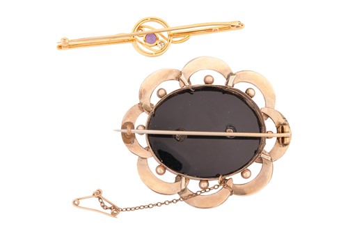 Lot 135 - Two brooches; comprising an amethyst and...