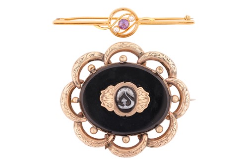Lot 135 - Two brooches; comprising an amethyst and...