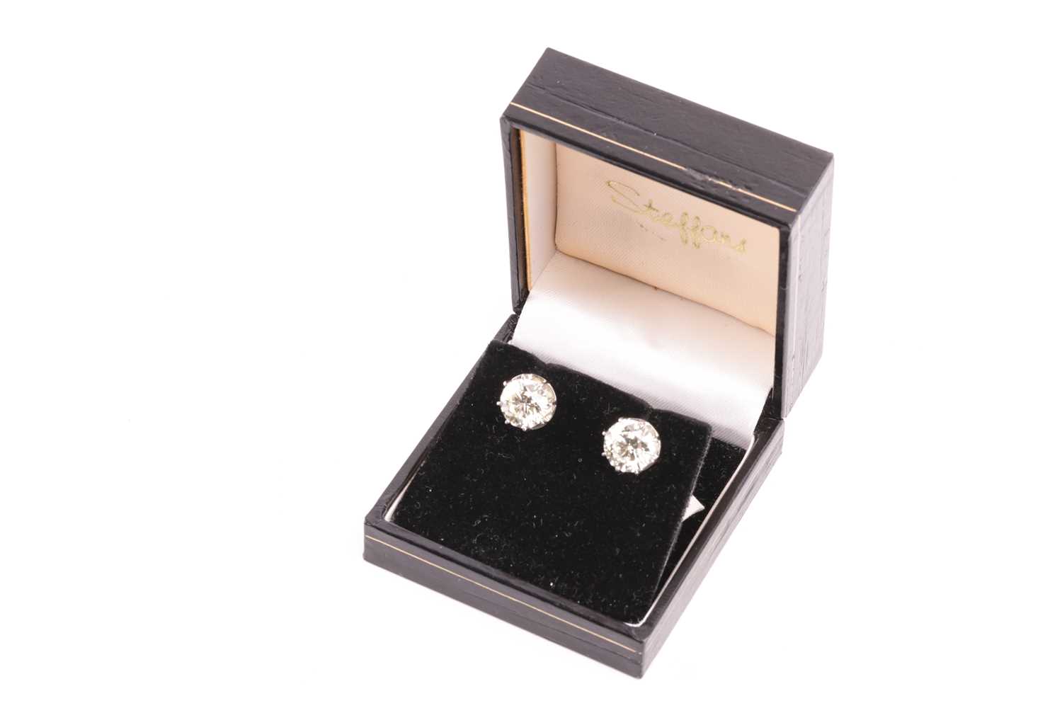 Lot 170 - A pair of diamond stud earrings, featuring two...