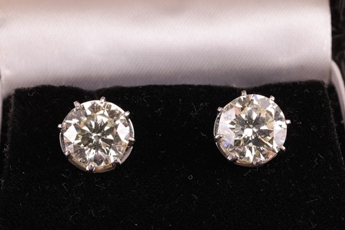 Lot 170 - A pair of diamond stud earrings, featuring two...