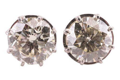 Lot 170 - A pair of diamond stud earrings, featuring two...