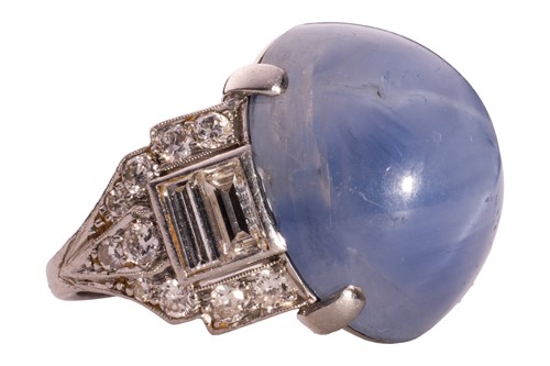 Lot 137 - A star sapphire and diamond ring, circa 1950s,...