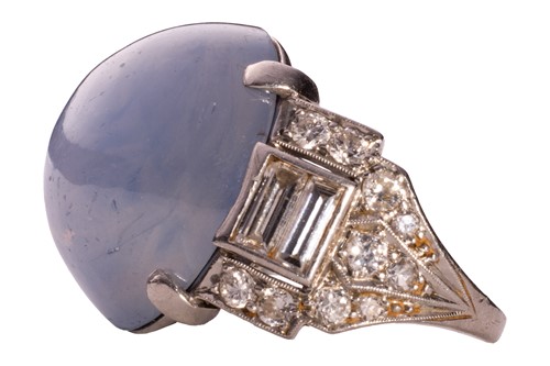 Lot 137 - A star sapphire and diamond ring, circa 1950s,...