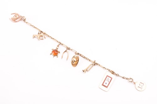 Lot A charm bracelet with various charms,...