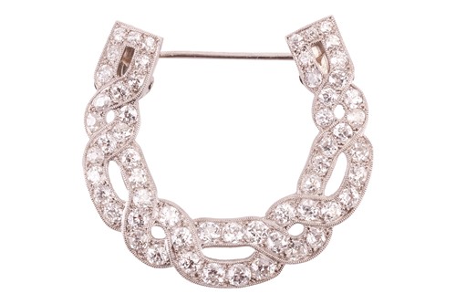 Lot 17 - A diamond horseshoe brooch, in a twisted...